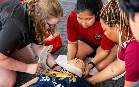 University of Indianapolis students learn helmet removal techniques.